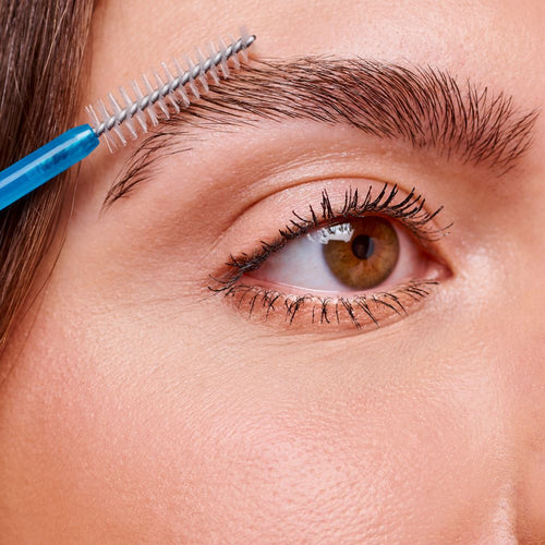 Close-up of the fiber brush applicator and transparent gel formula of Essence Lash & Brow Gel Mascara.