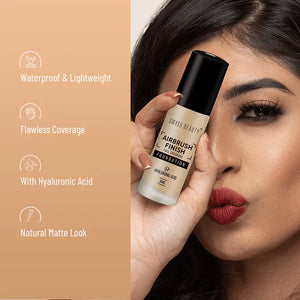 Woman holding Swiss Beauty Airbrush Finish Foundation bottle showing waterproof, lightweight, flawless coverage, hyaluronic acid, natural matte look